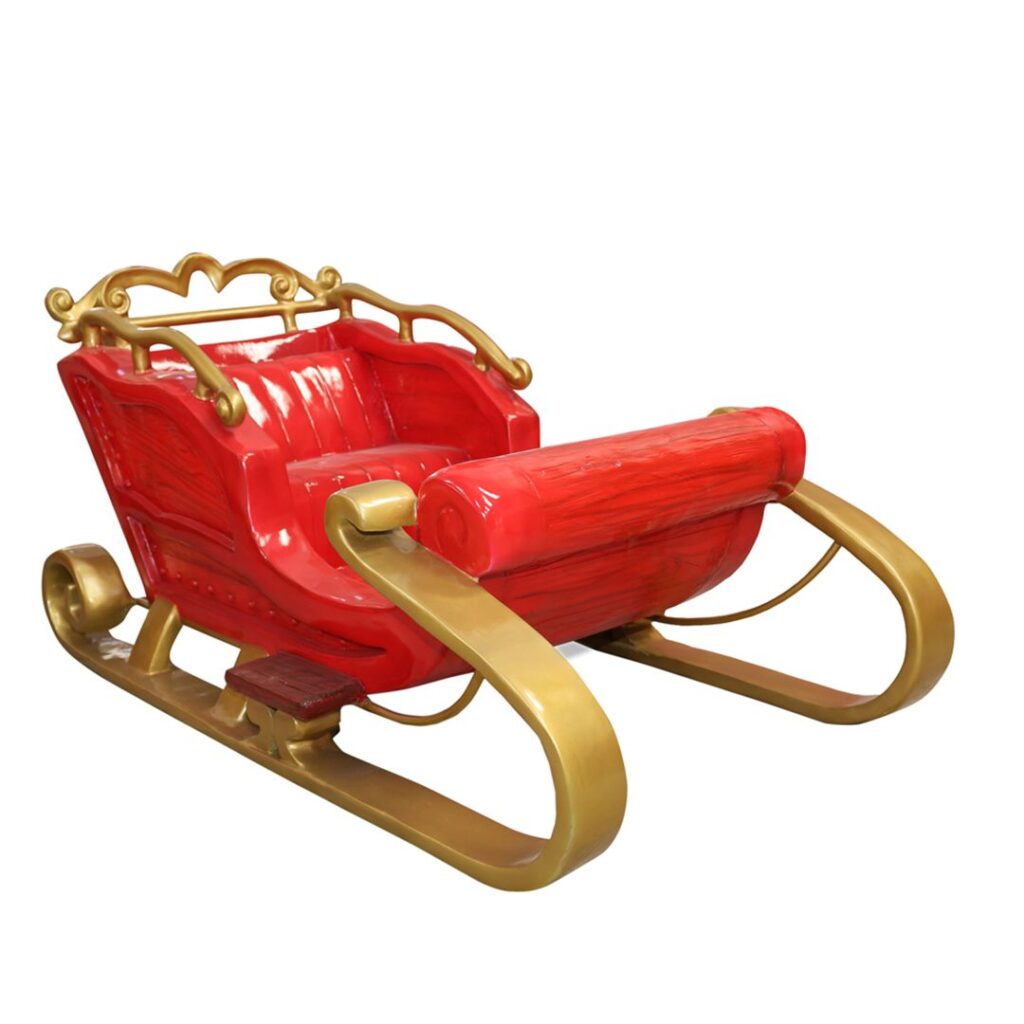 A small red sleigh, with wood patterns and gold accents.