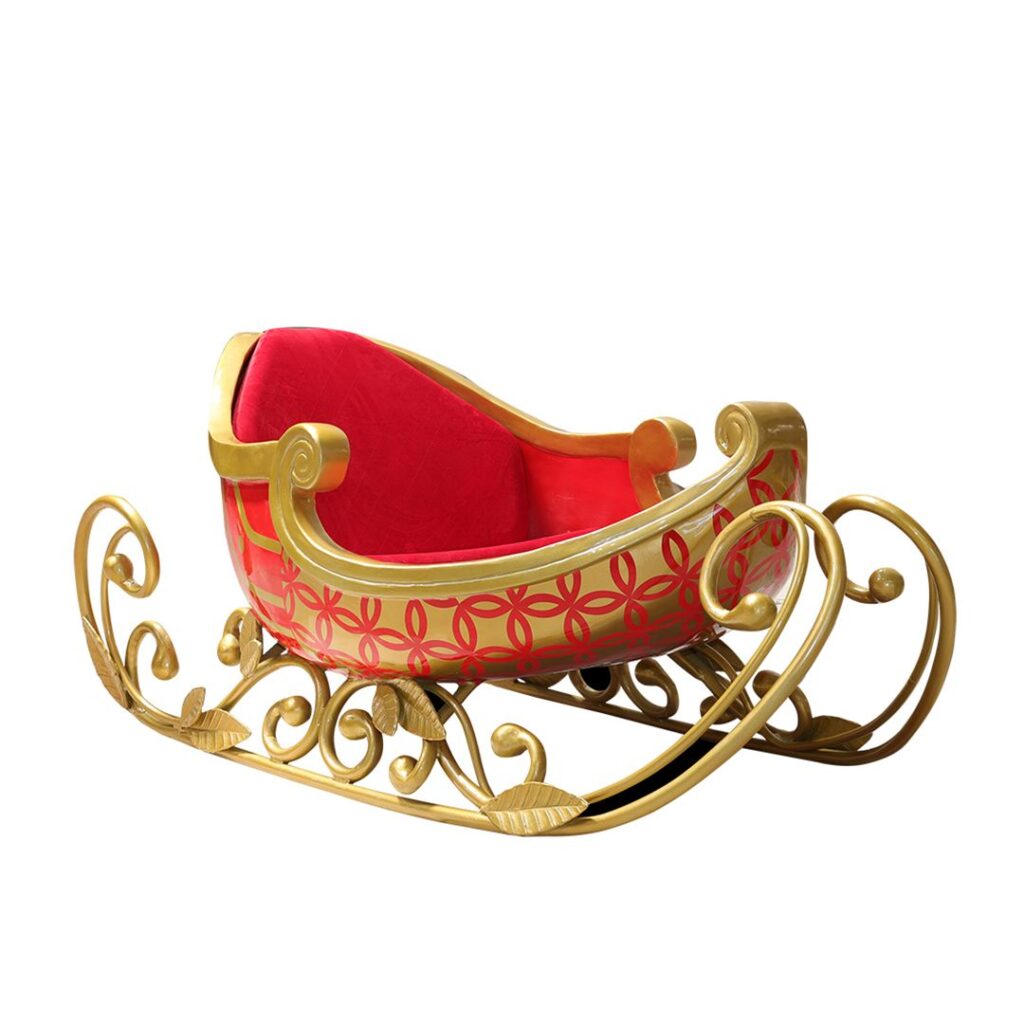 A gold sleigh with a red pattern and red upholstery.
