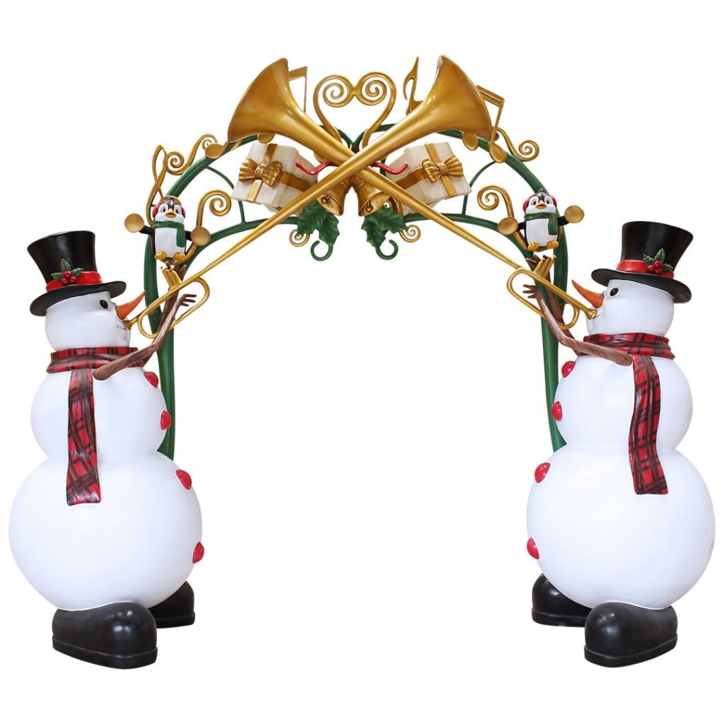 A large green archway with gold music notes and tow trumpet playing snowmen on either side.