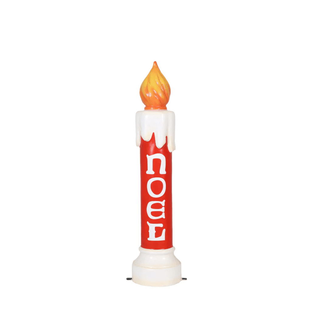 A red decorative lit candle with the word "NOEL" written on the front.
