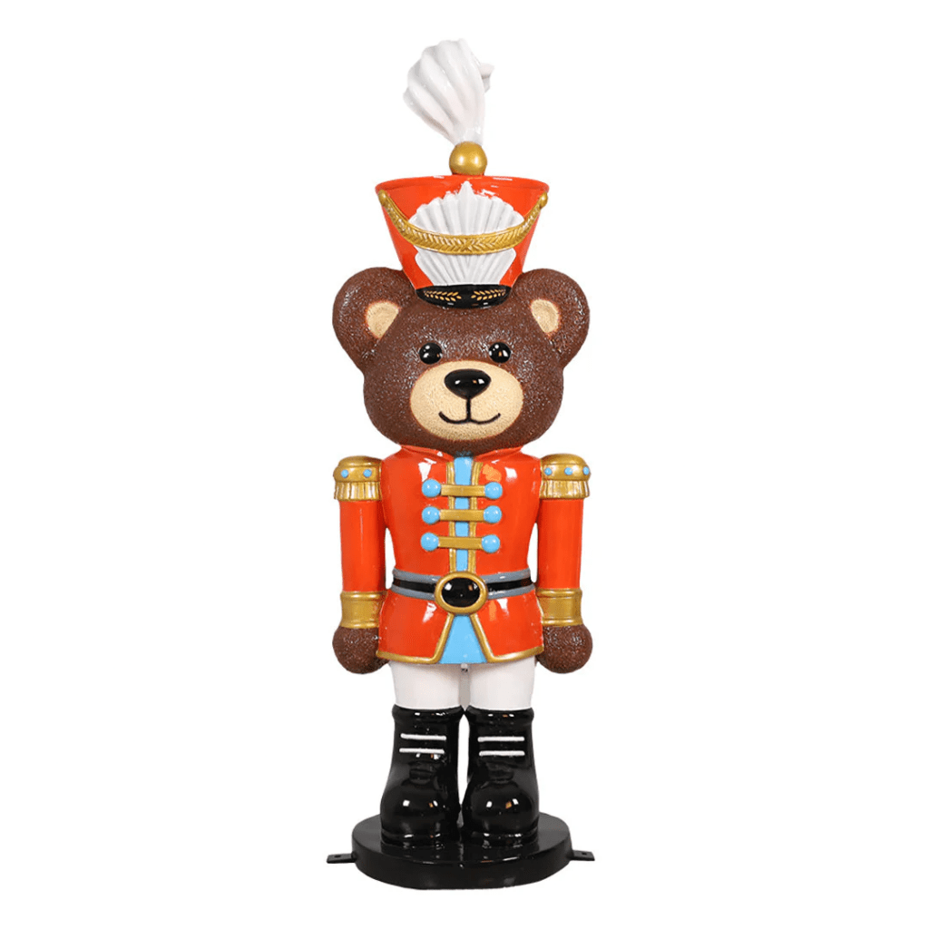 A teddy bear dressed as a toy soldier.