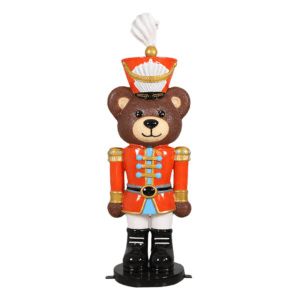 A teddy bear dressed as a toy soldier.