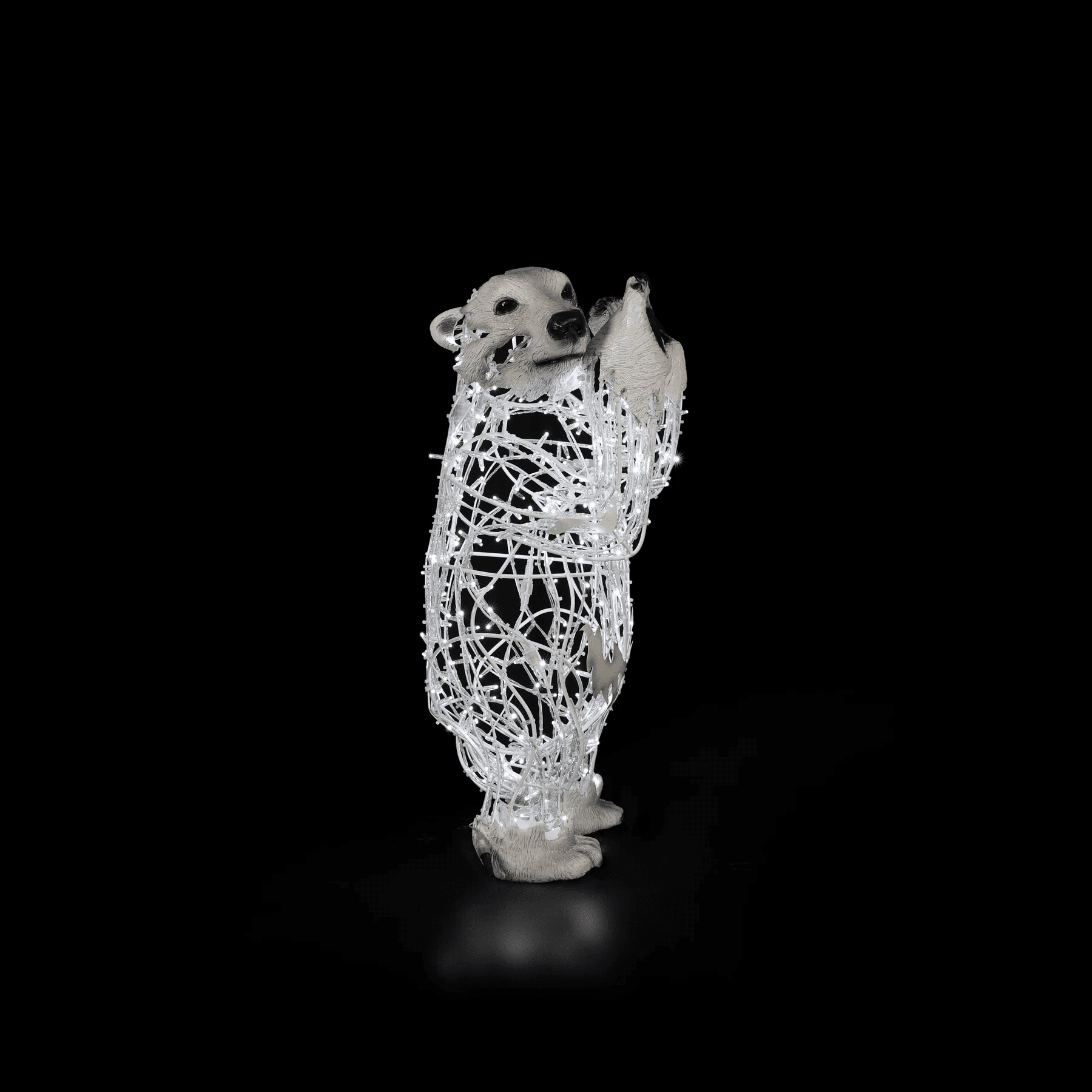 A standing baby polar bear made of white lights.
