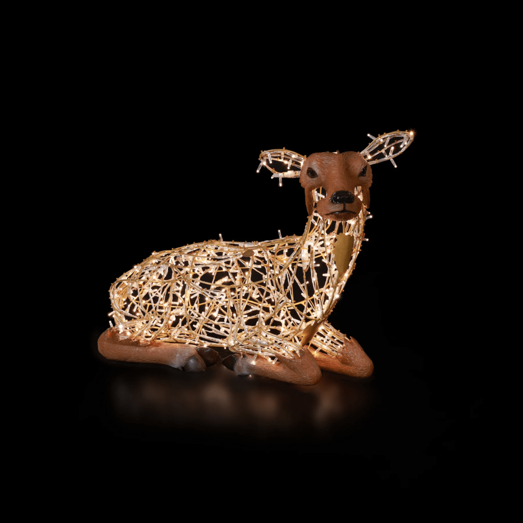 A small Doe, made of white lights, laying down.