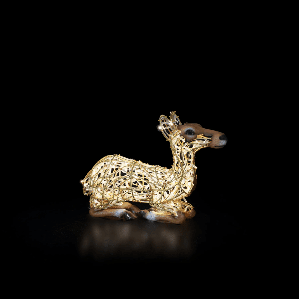 A small deer laying down, made of lights.