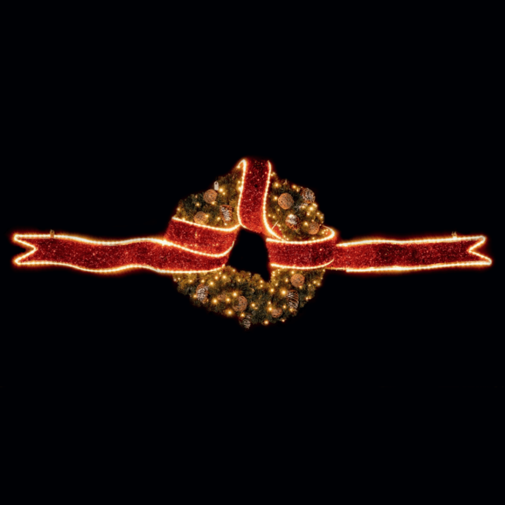 A long red ribbon made of red tinsel and warm white lights with a decorated wreath tied in the middle