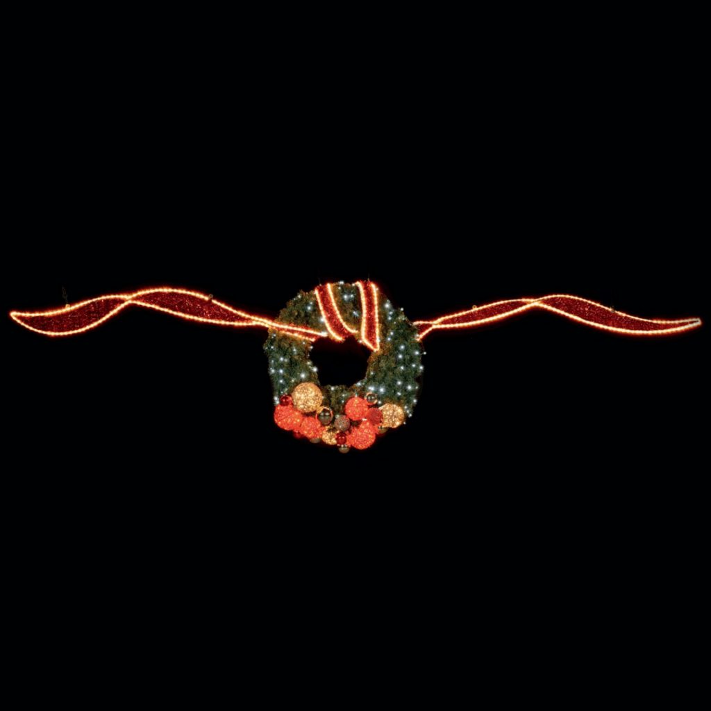 A long red ribbon made of red tinsel and warm white lights with a decorated wreath tied in the middle