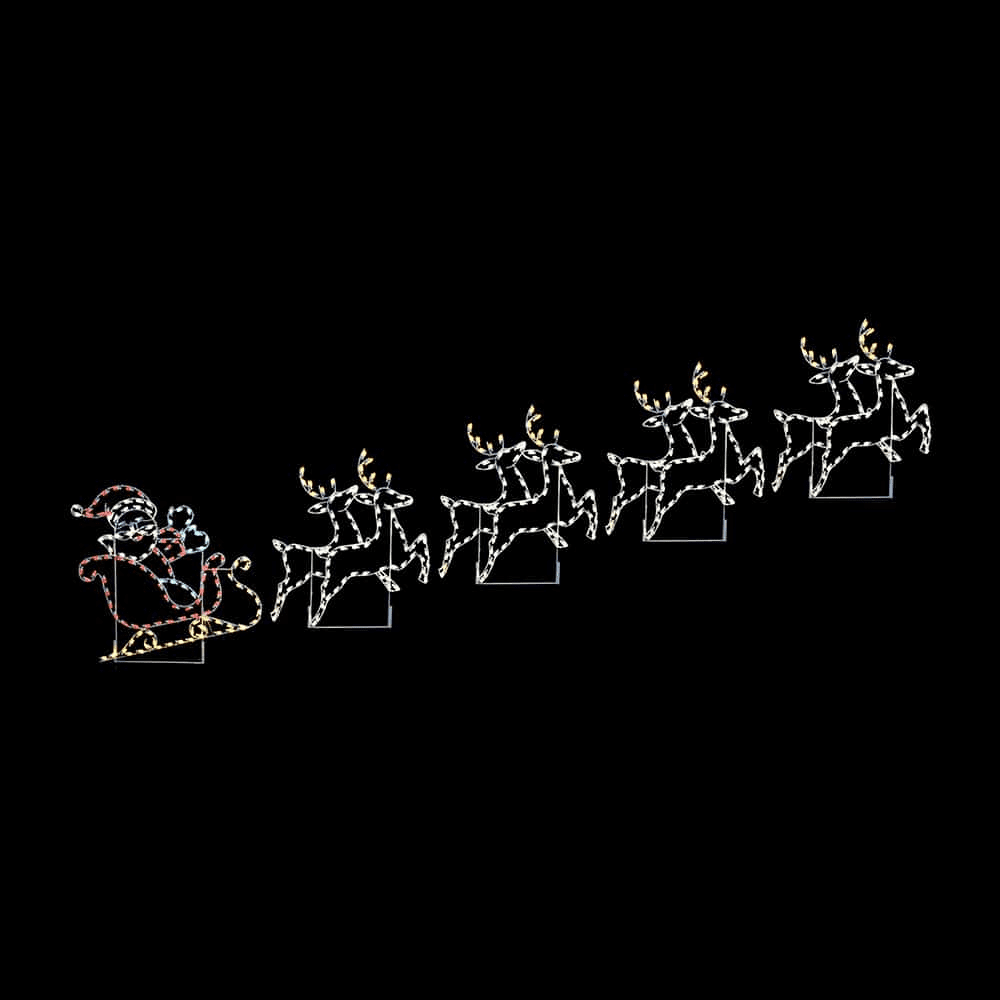 A lighted Christmas silhouette of Santa waving from his sleigh pulled by eight reindeer.