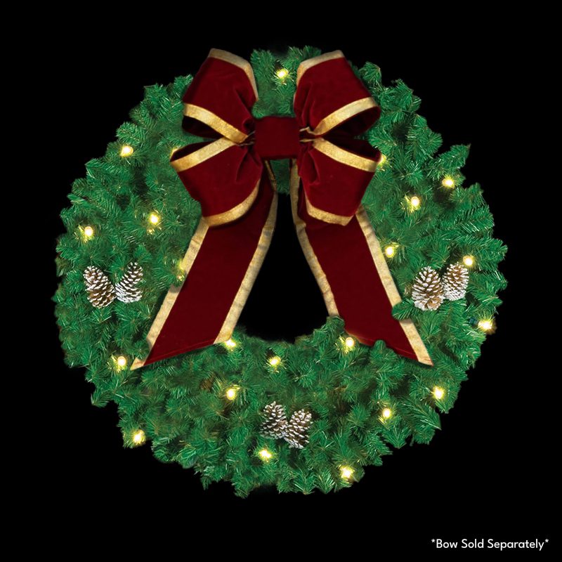 A wreath made of green pine garland with warm white C7 LED lights and pine cones with a dark red bow.