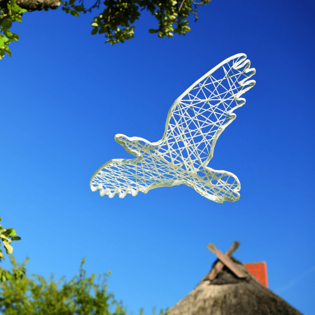 An image of a white, two dimensional bird made of lightweight and durable fiberglass.