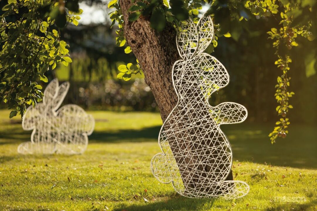 An image of a white two dimensional Easter bunny standing, made of strings of fiberglass.