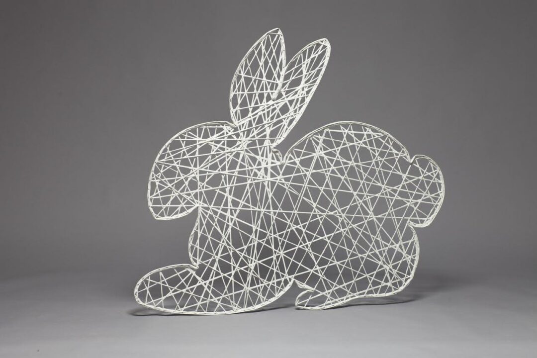 An image of a white two dimensional Easter bunny sitting on all four legs, made of strings of fiberglass.