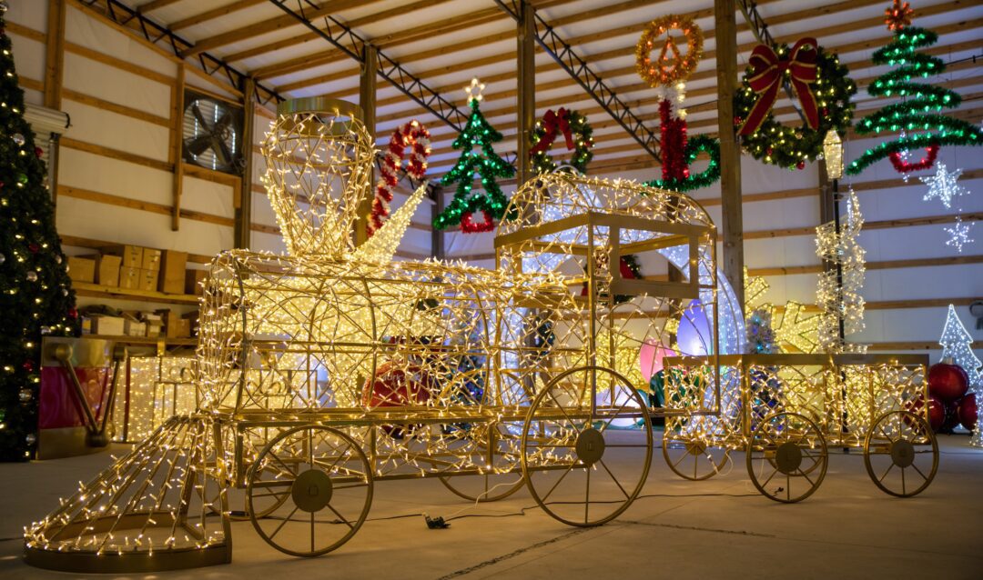 An image of a large train prop made of a gold metal frame and warm white LED lights.