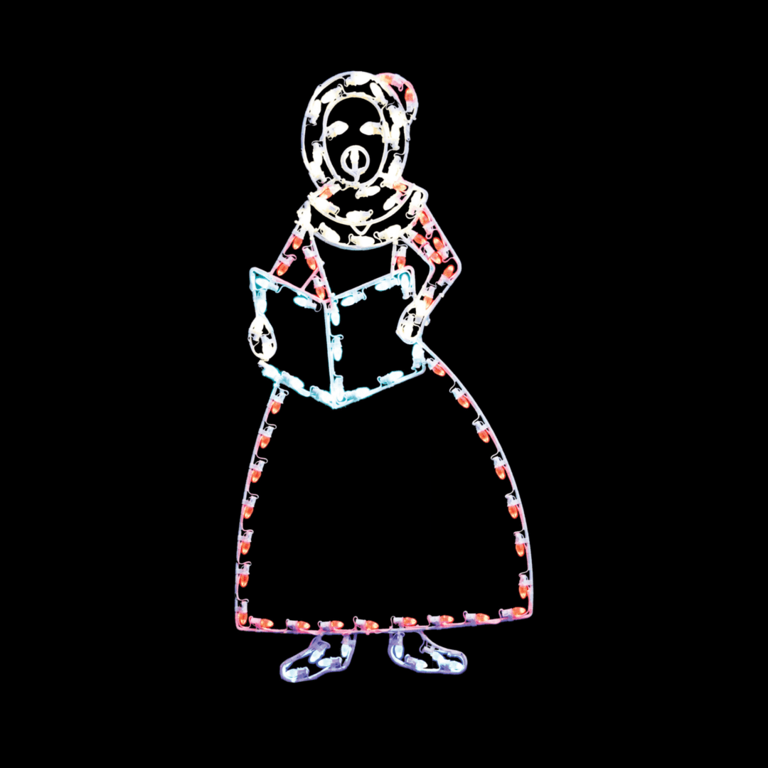 A lighted Christmas silhouette of a woman in a red dress, and holding a book, caroling.