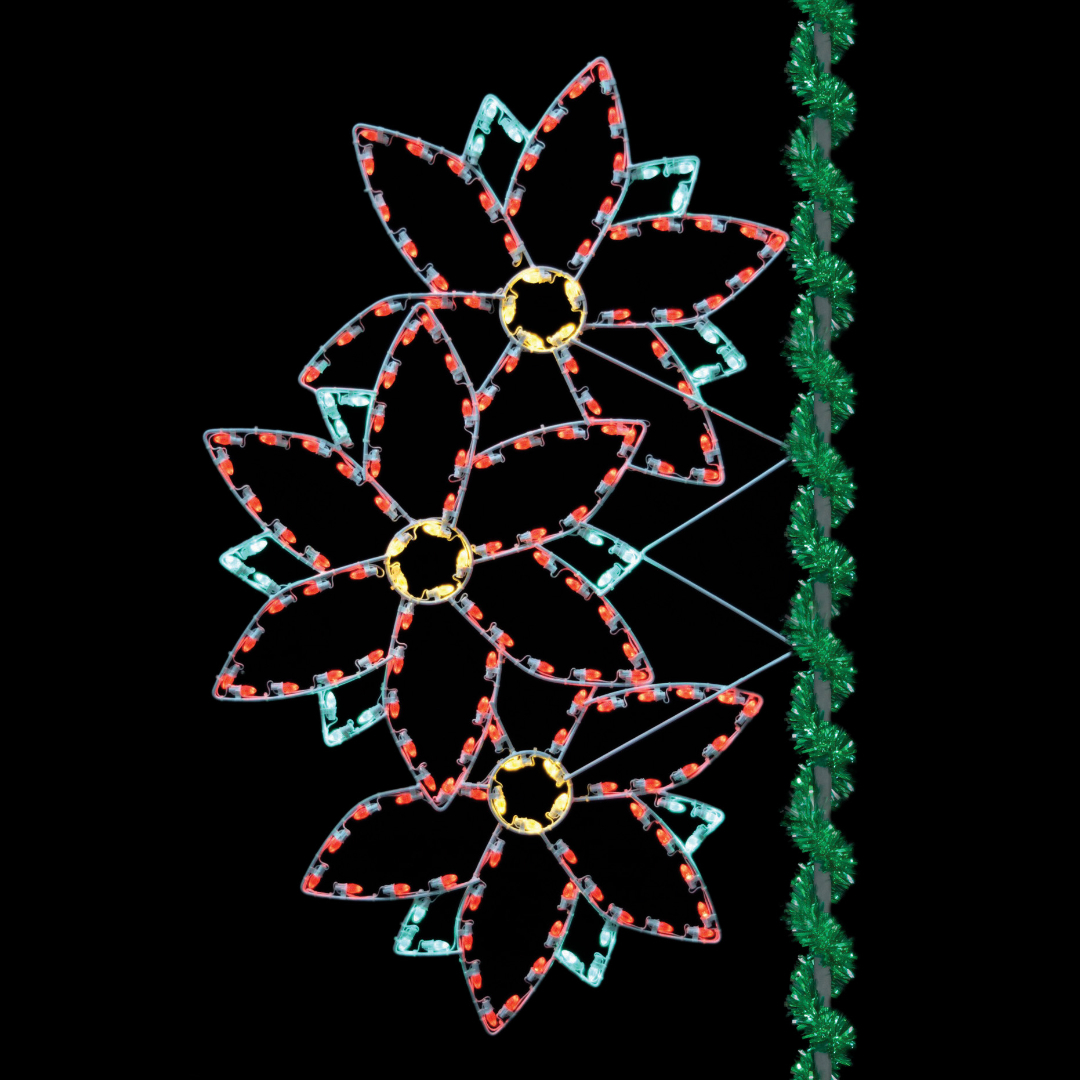 A lighted Christmas silhouette of three (3) poinsettias stacked on top of each other, and mounted on a pole wrapped in green tinsel garland.