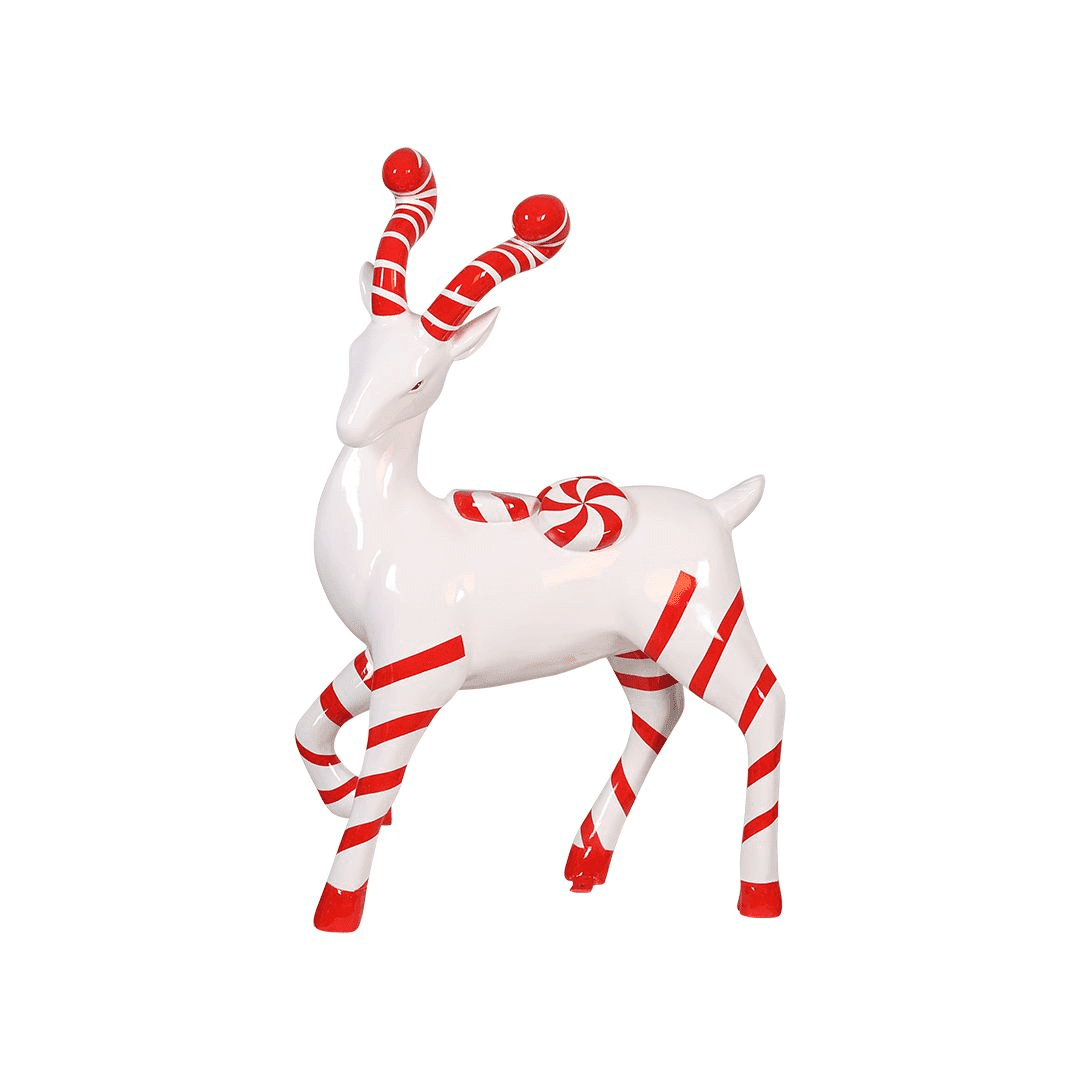 A statue of a white deer with red and white striped legs, and antlers. The deer also has two round peppermint candies on its back.