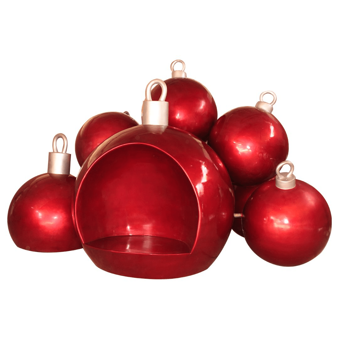 An image of a cluster of gold Christmas ornaments. The front ornament is hollowed out and has a seat inside.