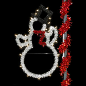 A Christmas light silhouette of a snowman wearing a black top hat and red scarf. The silhouette is made of white, black, and red tinsel garland and C7 LED lights.