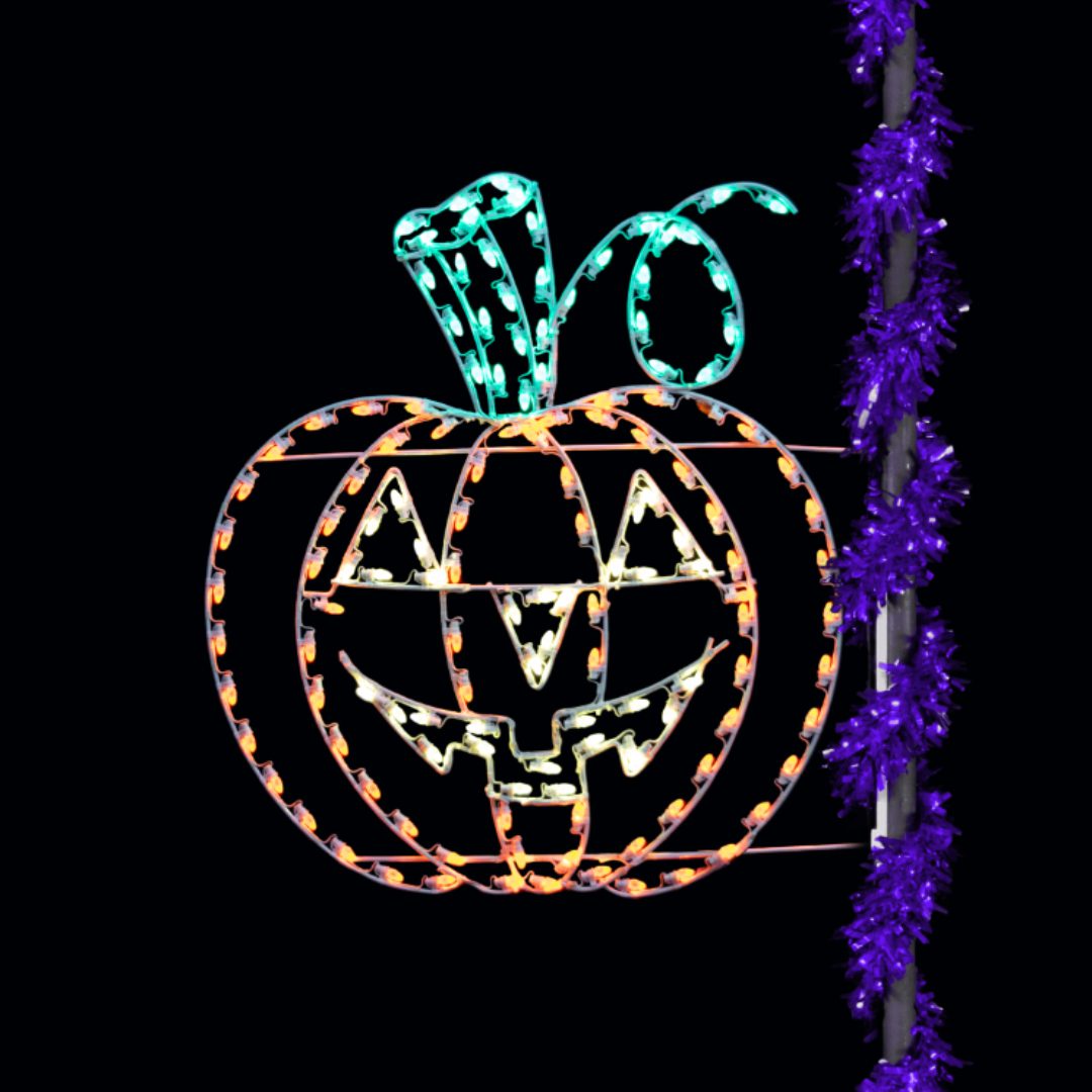 A Christmas light silhouette of an orange jack-o'-lantern smiling.