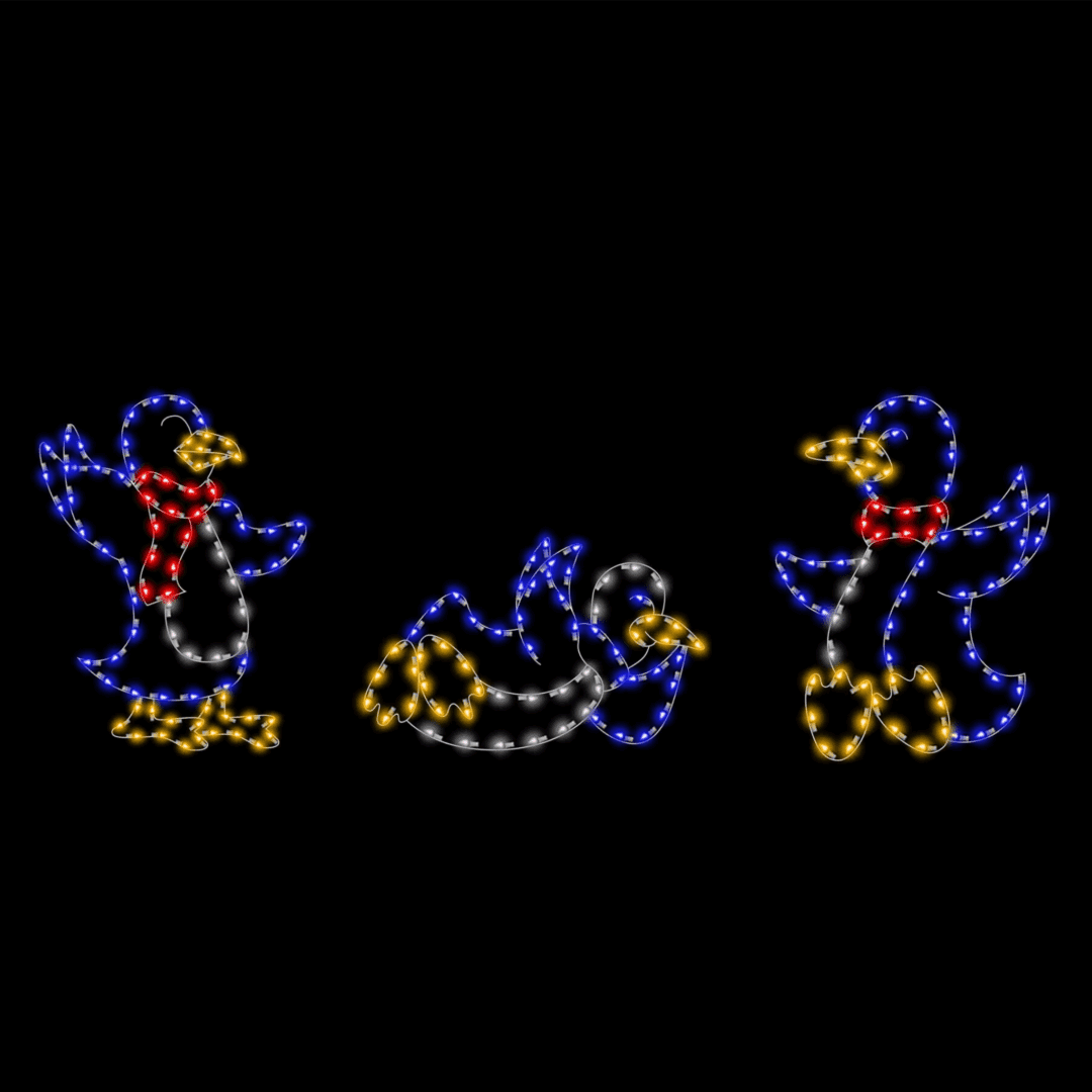 Three Christmas light silhouettes of penguins wearing scarfs and waving.