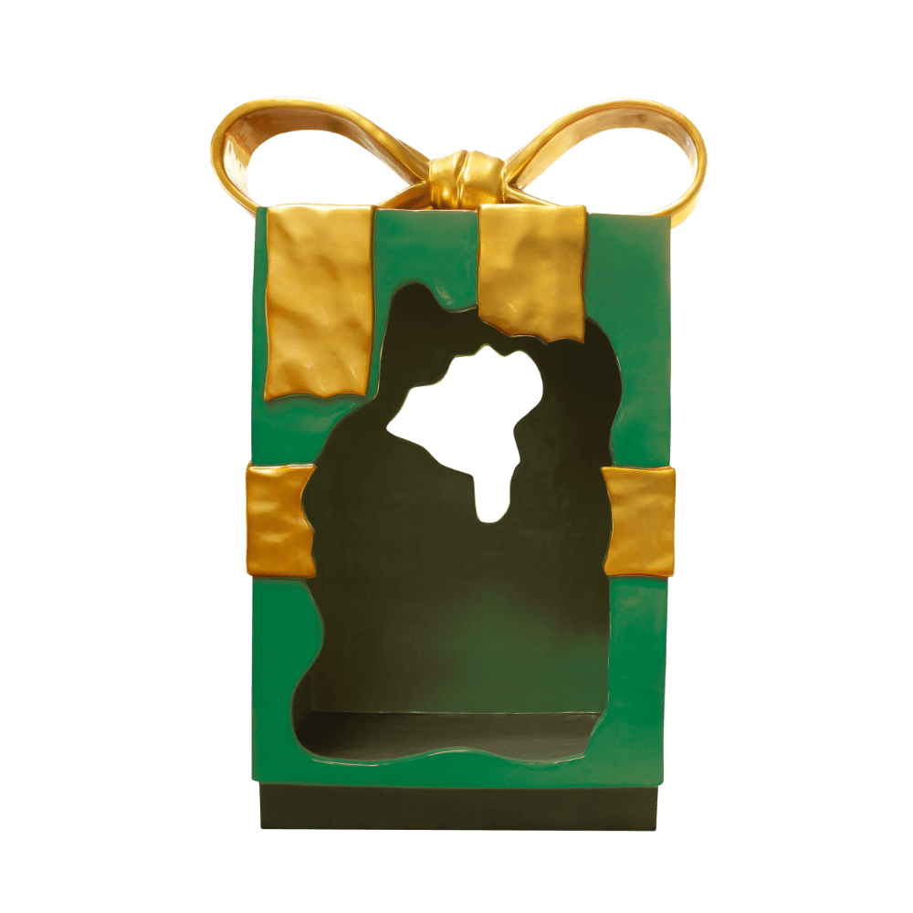 A large green Christmas parcel with a gold bow, torn open in the middle.