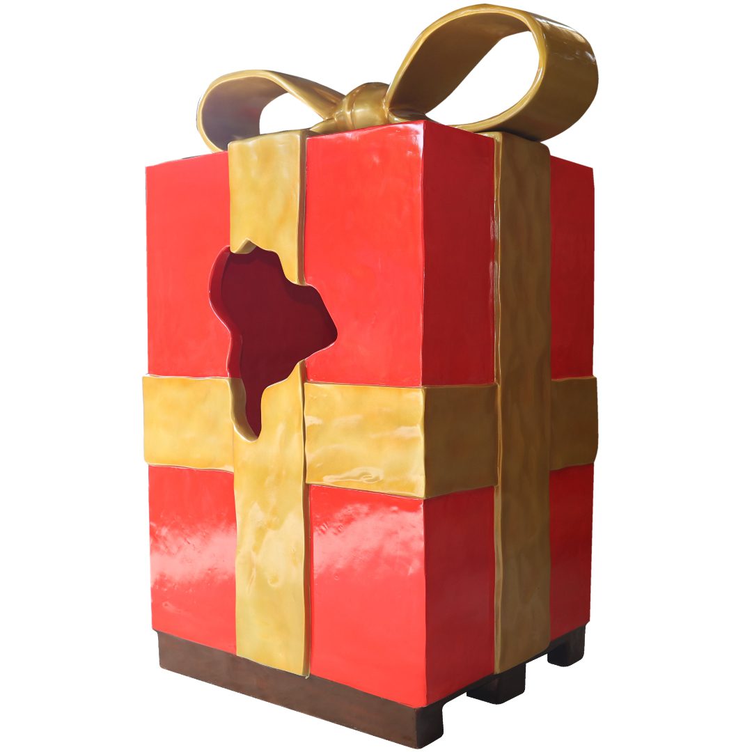 A large red Christmas parcel with a gold bow, torn open in the middle.