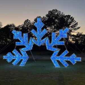 Half of a large snowflake in archway form. Made from a large metal frame and blue LED lights.