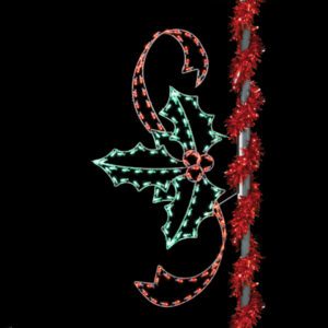 A pole-mounted Christmas light silhouette of holly leaves and berries and a red swirling ribbon.