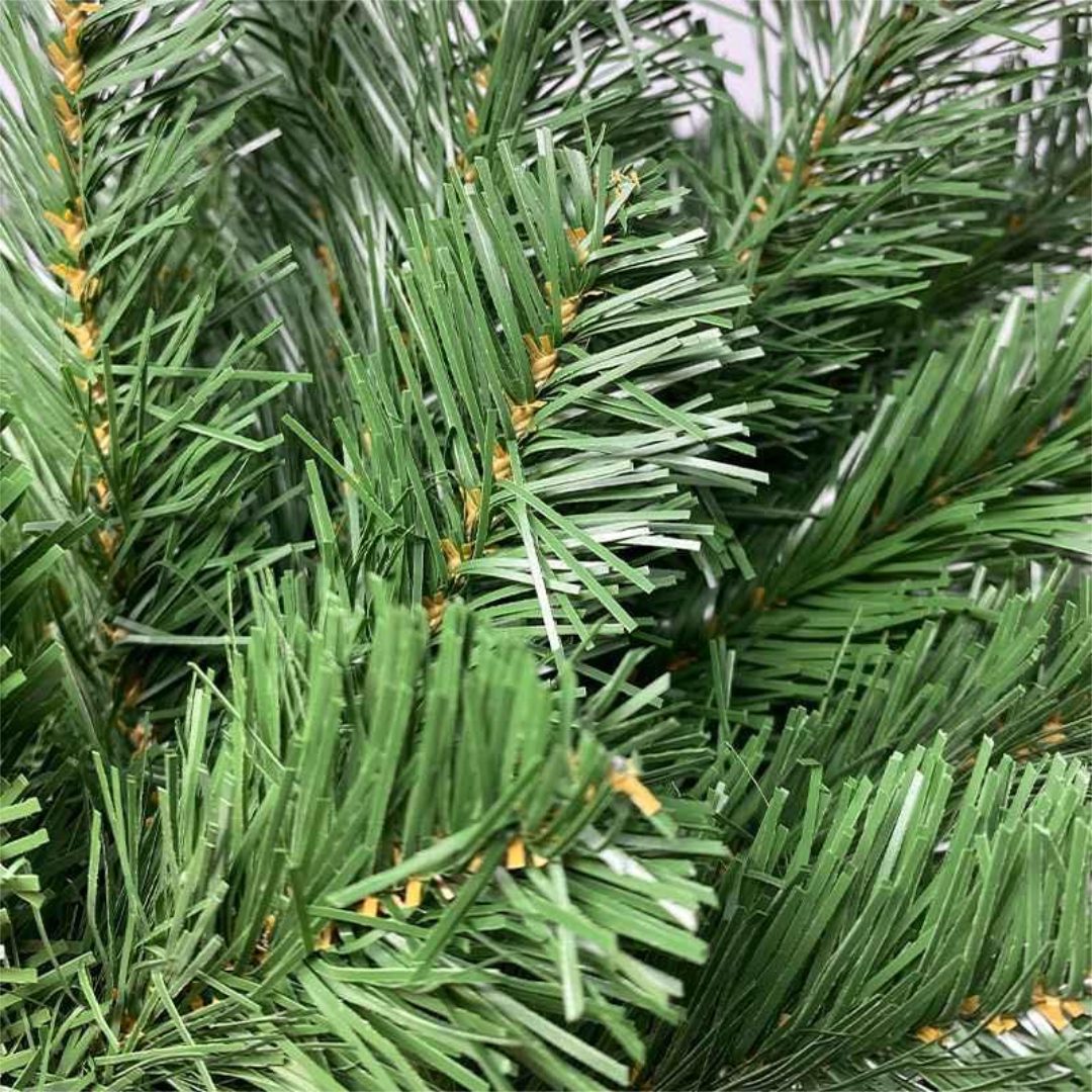 A close-up image of green artificial Christmas tree needles.