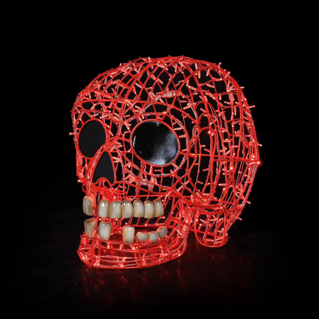 A Christmas light display of a 3D smiling human skull made from red mini LED Christmas lights.